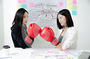 Two asian business women fight. Angry women, looking at each other with hatred, blaming for problem. Friendship difficulties,