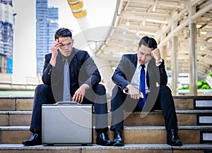 Two asian Businessman feel sad and frustrated upset fail in life