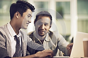 Two asian businessmen having a business discussion in office