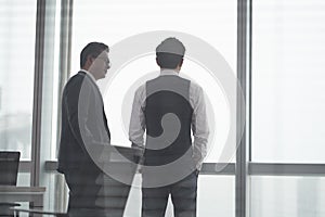 Two asian businessmen talking in office