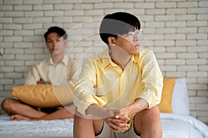 Two Asian gay or lgbt man stay in bedroom and express sad or bad emotion from arguement or controversial problem