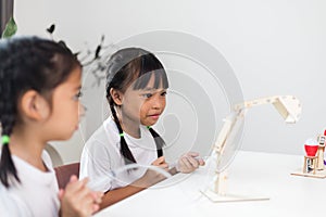 two Asian girl is studying the work of work