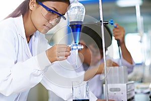 Two Asian Laboratory scientist working at lab with test tubes