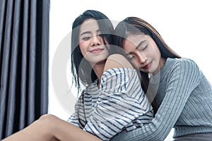 Two Asian Lesbian women hug together in bedroom. Couple people and Beauty concept. Happy lifestyle and home sweet home theme.
