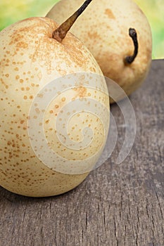 Two asian pears on old wooden table