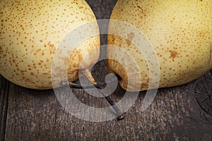 Two asian pears on old wooden table