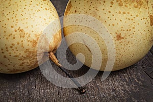 Two asian pears on old wooden table