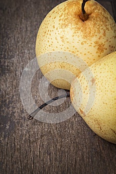 Two asian pears on old wooden table