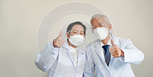 Two Asian senior doctors scientist show successful victory gestu