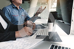 Two asian team working development of programming and encryption technology website design programmers on desk in office