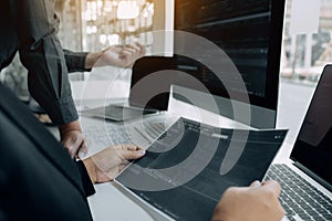 Two asian team working development of programming and encryption technology website design programmers on desk in office