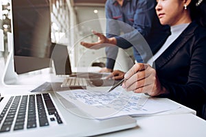 Two asian team working development of programming and encryption technology website design programmers on desk in office