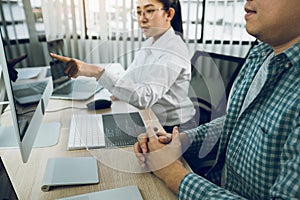 Two asian team working development of programming and encryption technology website design programmers on desk in office