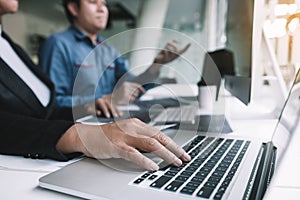 Two asian team working development of programming and encryption technology website design programmers on desk in office