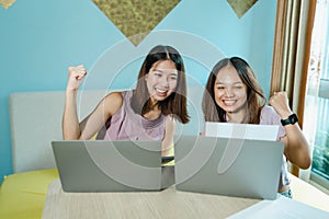 Two Asian teens work together to show off their joyful accomplishments. Complete work in order to have a pleasant vacation in your