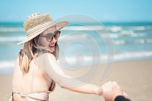 Two Asian women jogging on the beach in the morning. Rest time and holidays