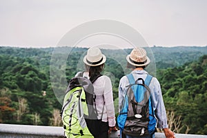 two asian woman tourist looking view forest on mountian. travel in holiday concept