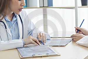 Two asian women doctors discuss meeting doctor's office medical clinic looking x-ray film consulting patient disease. Asian