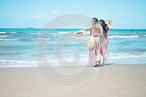 Two Asian women jogging on the beach in the morning. Rest time and holidays