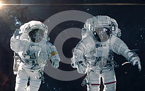 Two astronauts on background of nebulae and star clusters. Deep space landscape. Science fiction