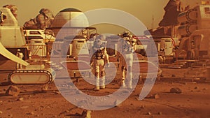 Two astronauts walk toward research station on Mars
