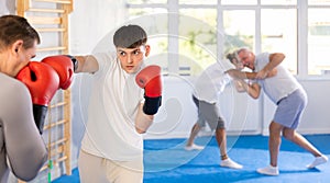 Two athlete men in sportswear practicing boxing sparring in hall