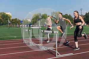 Two athlete woman and man runnner running hurdles