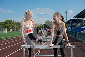 Two athlete young woman runnner at the stadium