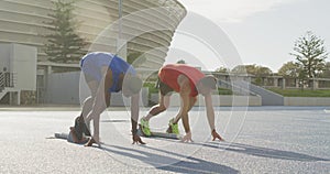 Two athletes preparing for race in stadium
