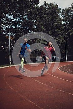 Two athletic man running fast outdoor