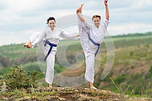 Two athletic women in martial arts tunics