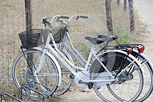 Two attached bicycles near the beach