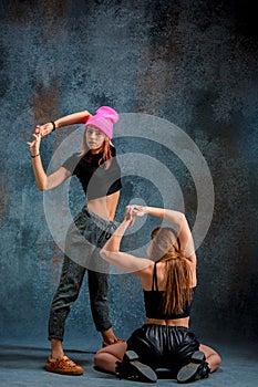 The two attractive girls dancing twerk in the studio