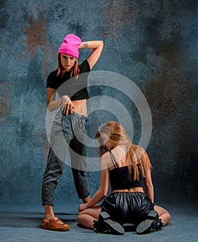 The two attractive girls dancing twerk in the studio