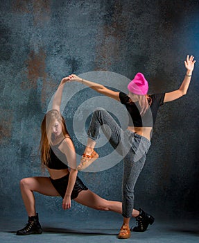 The two attractive girls dancing twerk in the studio