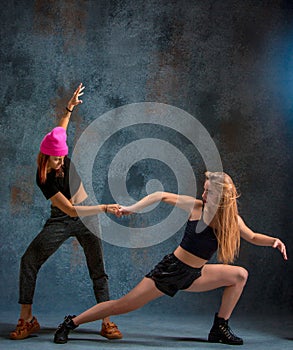 The two attractive girls dancing twerk in the studio