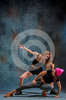 The two attractive girls dancing twerk in the studio