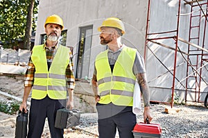 two attractive men in safety helmets