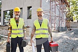 two attractive men in safety helmets