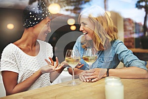 Two attractive women enjoying a glass of wine