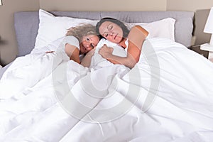 Two attractive women going to sleep in bed