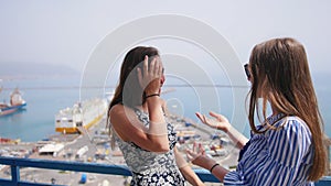 Two attractive women met unexpectedly on the observation deck at the docks.