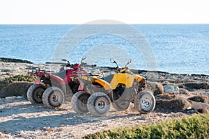 Two ATVs on the sea shore