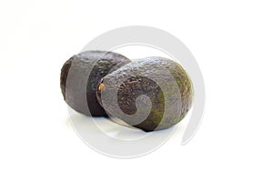 Two avocado fruits on a white isolated background.