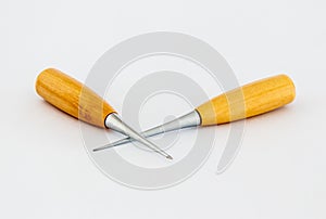 Two awls  for shoemakers with a wooden handle on a white background