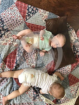 Two babies on Colorful Quilt