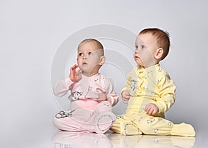 two babies talking on white background.