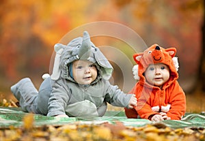 Two baby boys dressed in animal costumes