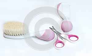 Two baby combs and pink baby scissors