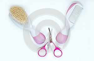 Two baby combs and pink baby scissors